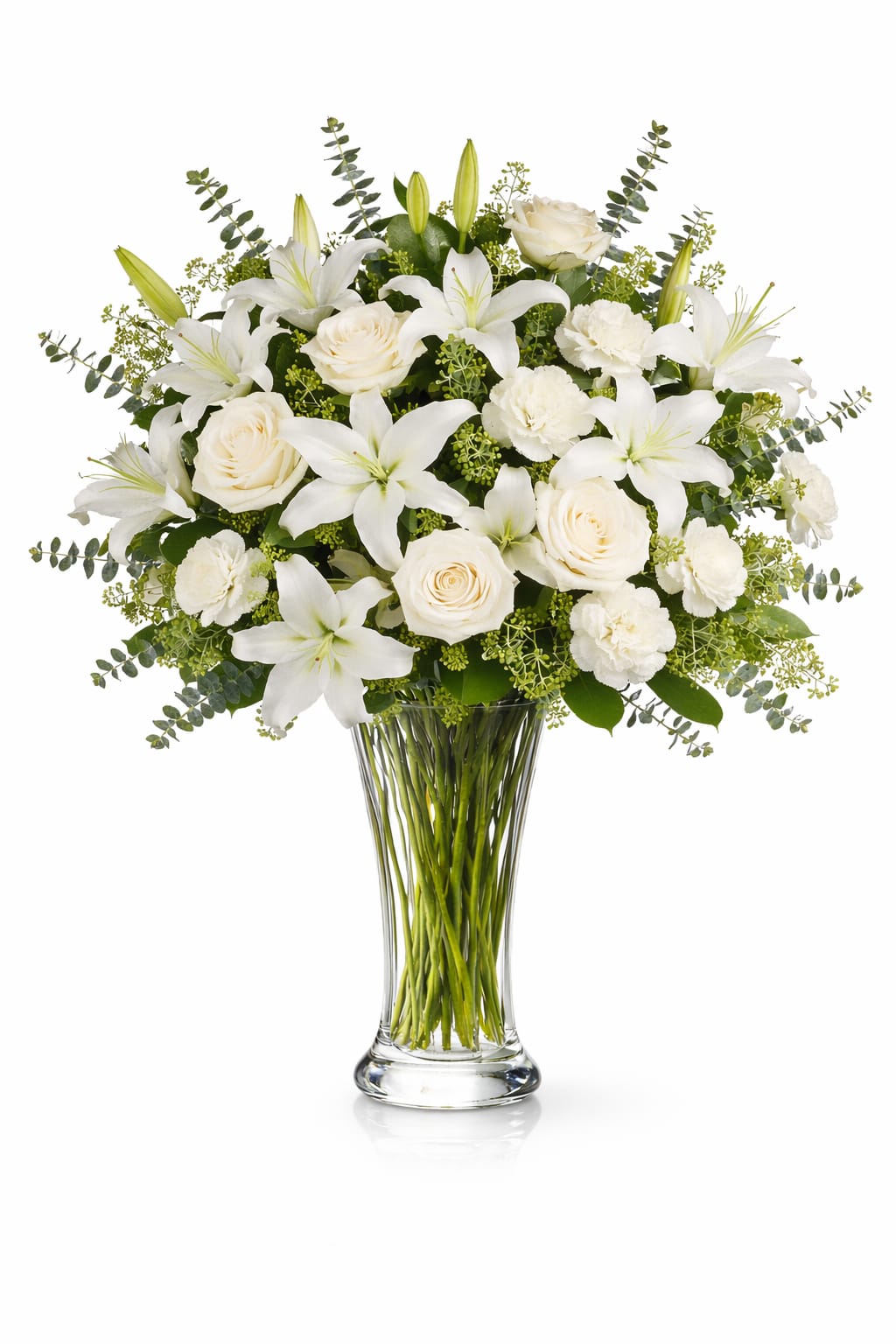 White lilies, roses, and carnations in a clear glass vase