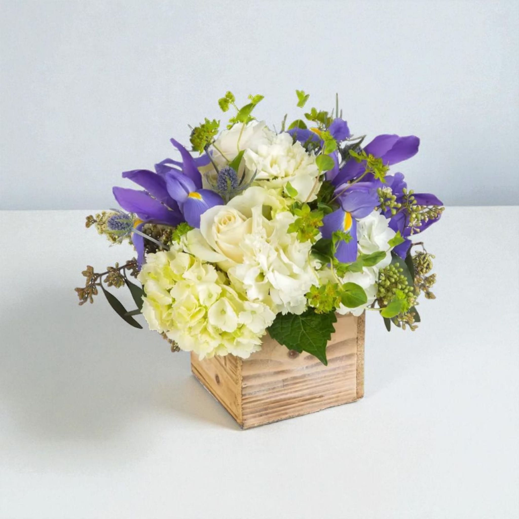 Breath of Fresh Air  - This is the perfect gift for someone who can use some R &amp; R. The arrangement contains roses, carnations, blue iris, and other seasonal blooms. 