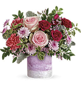 Pink and red roses in a lavender vase