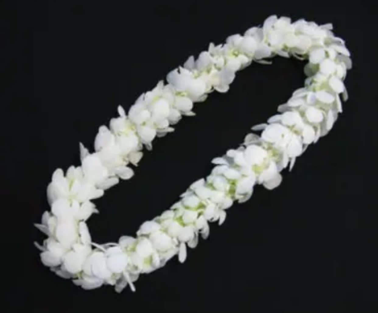 White flower lei on a black background