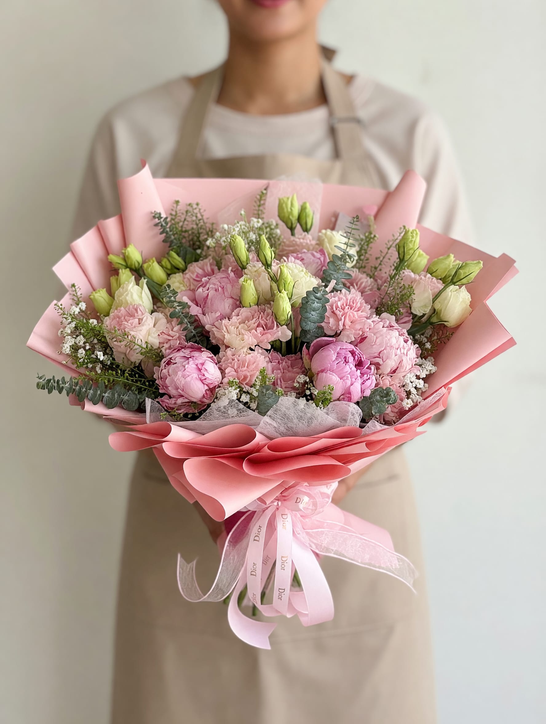 Peonies (5) &amp; Lisianthus Chic Bouquet  - Romantic, full, and effortlessly elegant — our Blush Garden Luxe Bouquet is designed to make a lasting impression.  This lush arrangement features a beautiful mix of premium pink blooms including peonies, carnations, and lisianthus, accented with delicate baby’s breath and fresh greenery for a soft garden-inspired look. Wrapped in layered blush-toned paper and finished with a luxury satin ribbon, this bouquet embodies femininity and elegance.  Perfect for Mother’s Day, birthdays, or special moments, this design offers a rich, full look with a soft and romantic feel. Each bouquet is handcrafted fresh to order using high-quality, seasonal flowers.  Please note: Peonies may arrive more closed and will naturally bloom beautifully within 1–2 days.