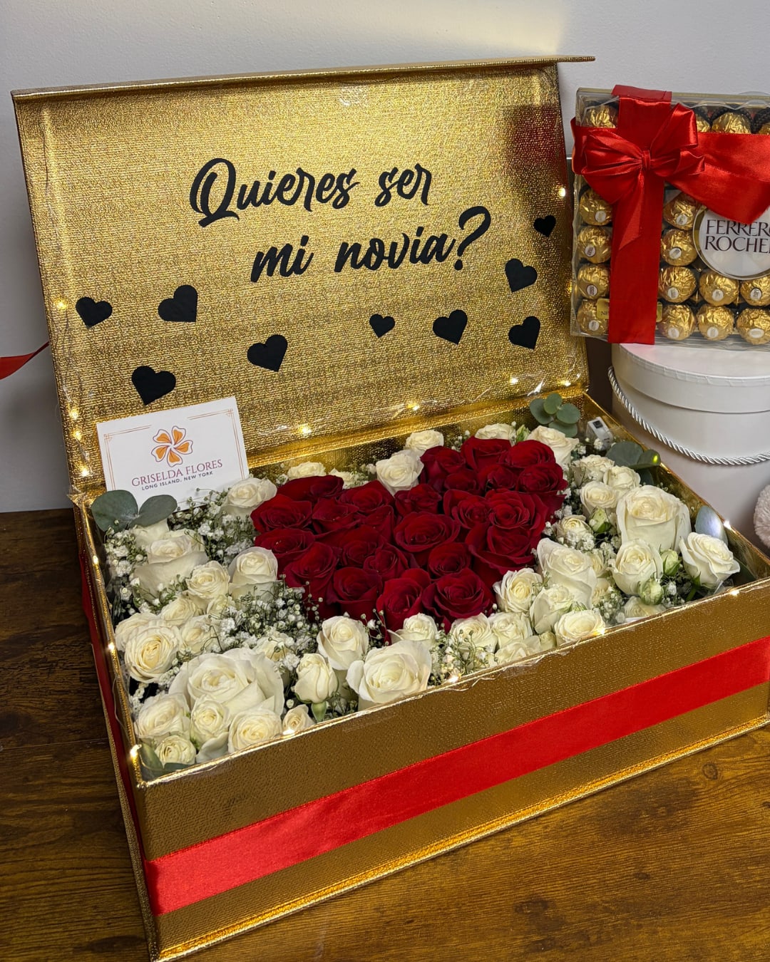 Gold gift box with red and white roses and a Ferrero Rocher box