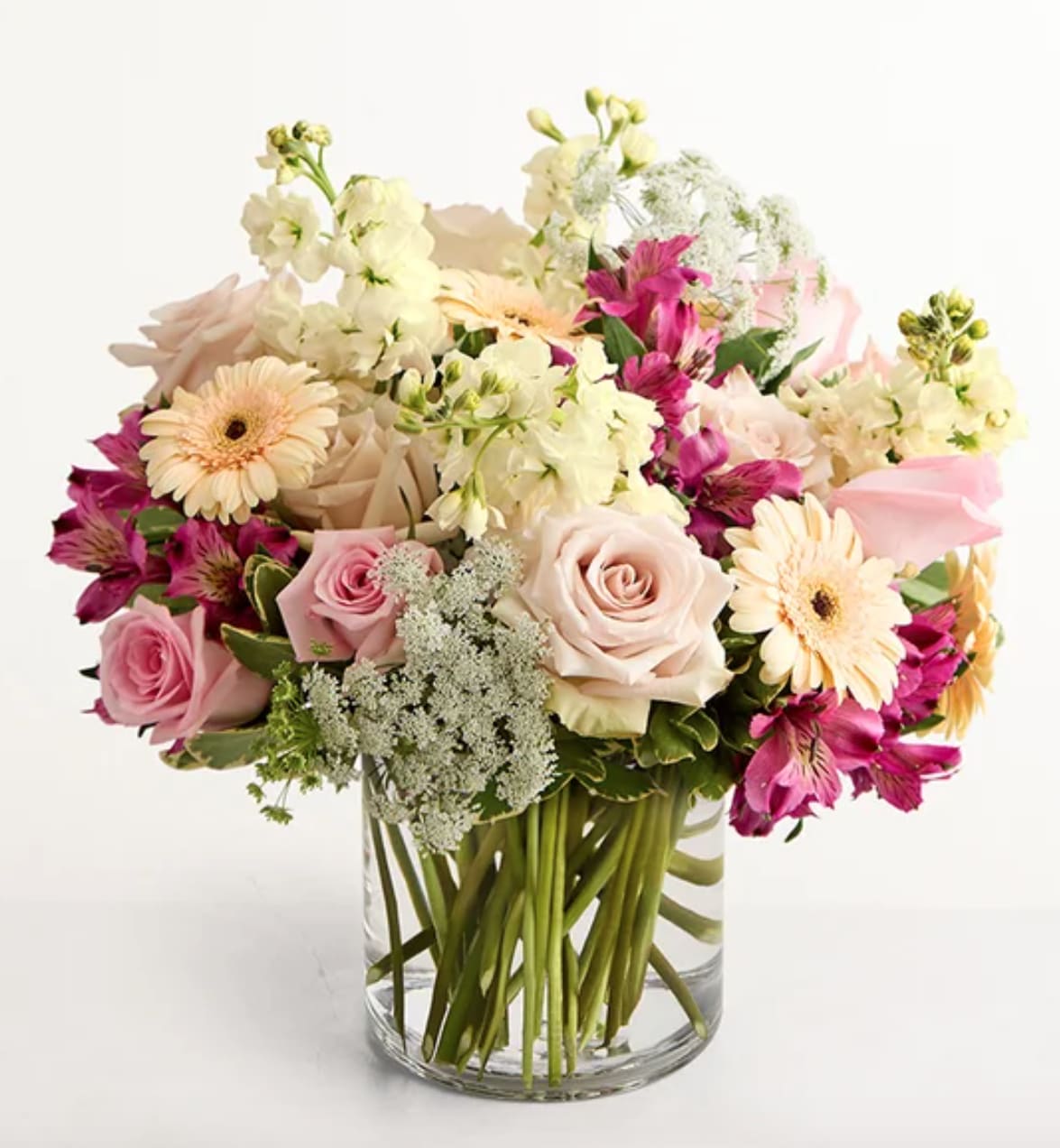 Pink and cream mixed bouquet in a clear glass vase