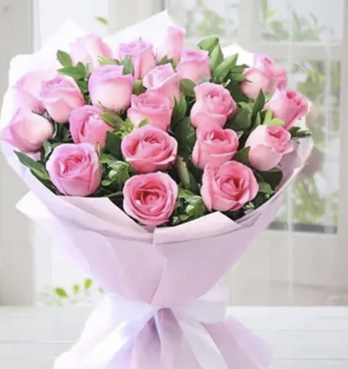 Pink rose bouquet wrapped in pale pink paper