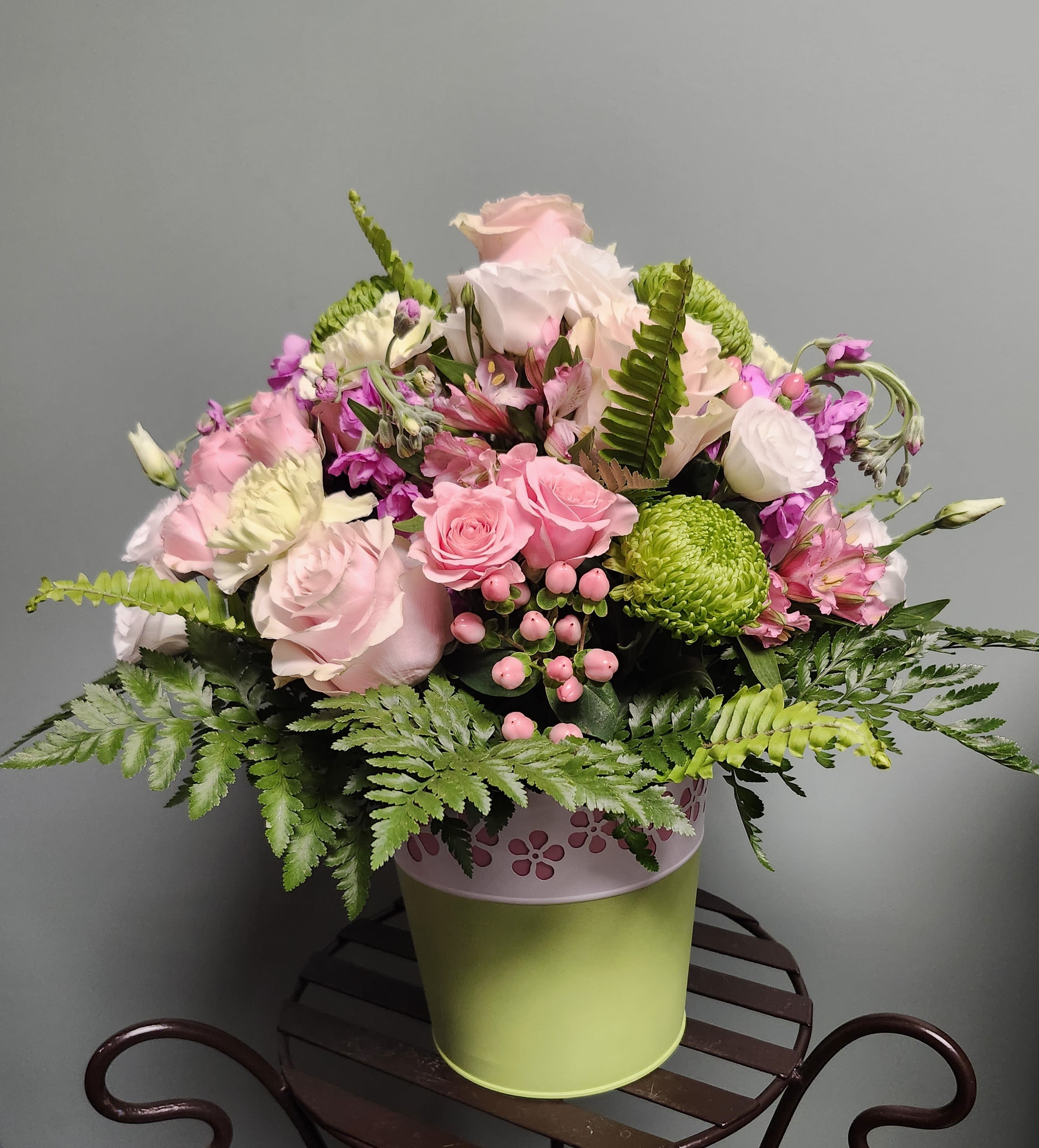 One Great Gift! - The striking green, and white tin has a contrasting pink floral cutout. This delightful arrangement will be filled with coordinating blooms and fillers to create a masterpiece splash of color coordinating wonder!  A great gift!
