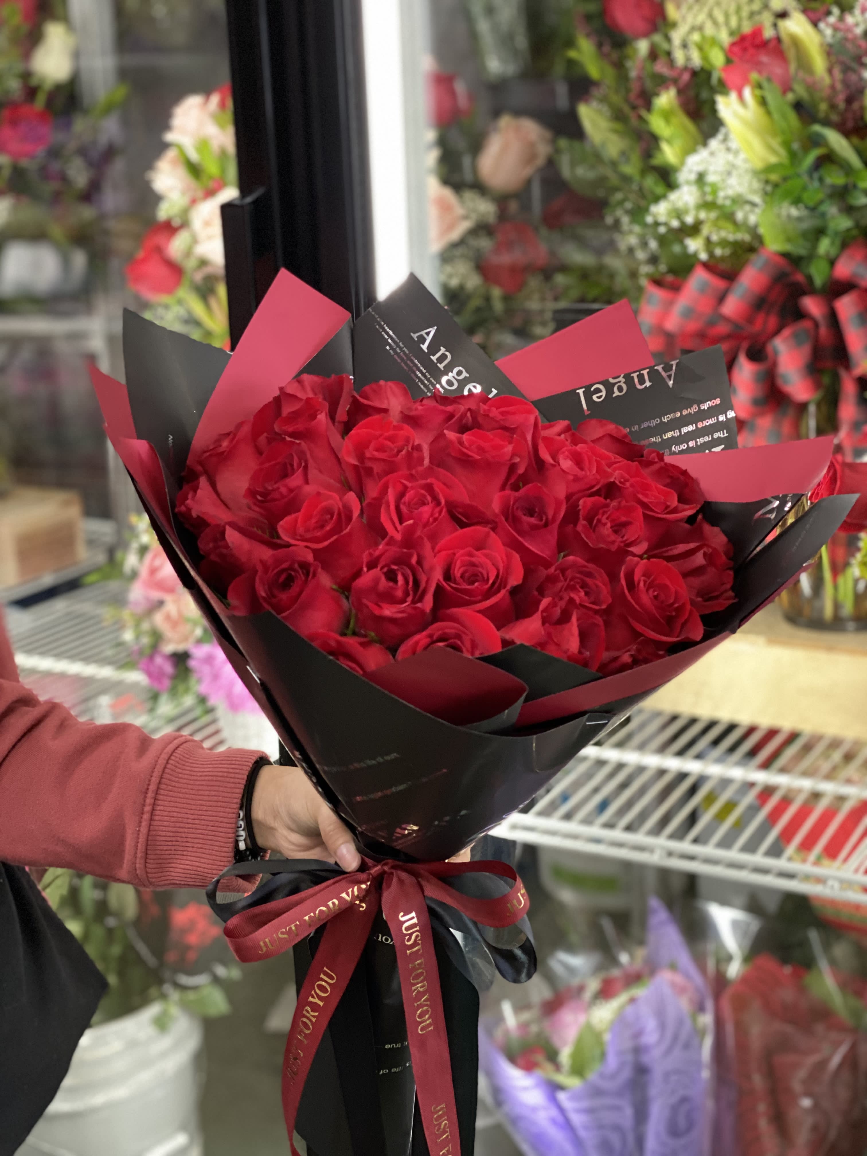 Bouquet of red roses wrapped in black and red paper