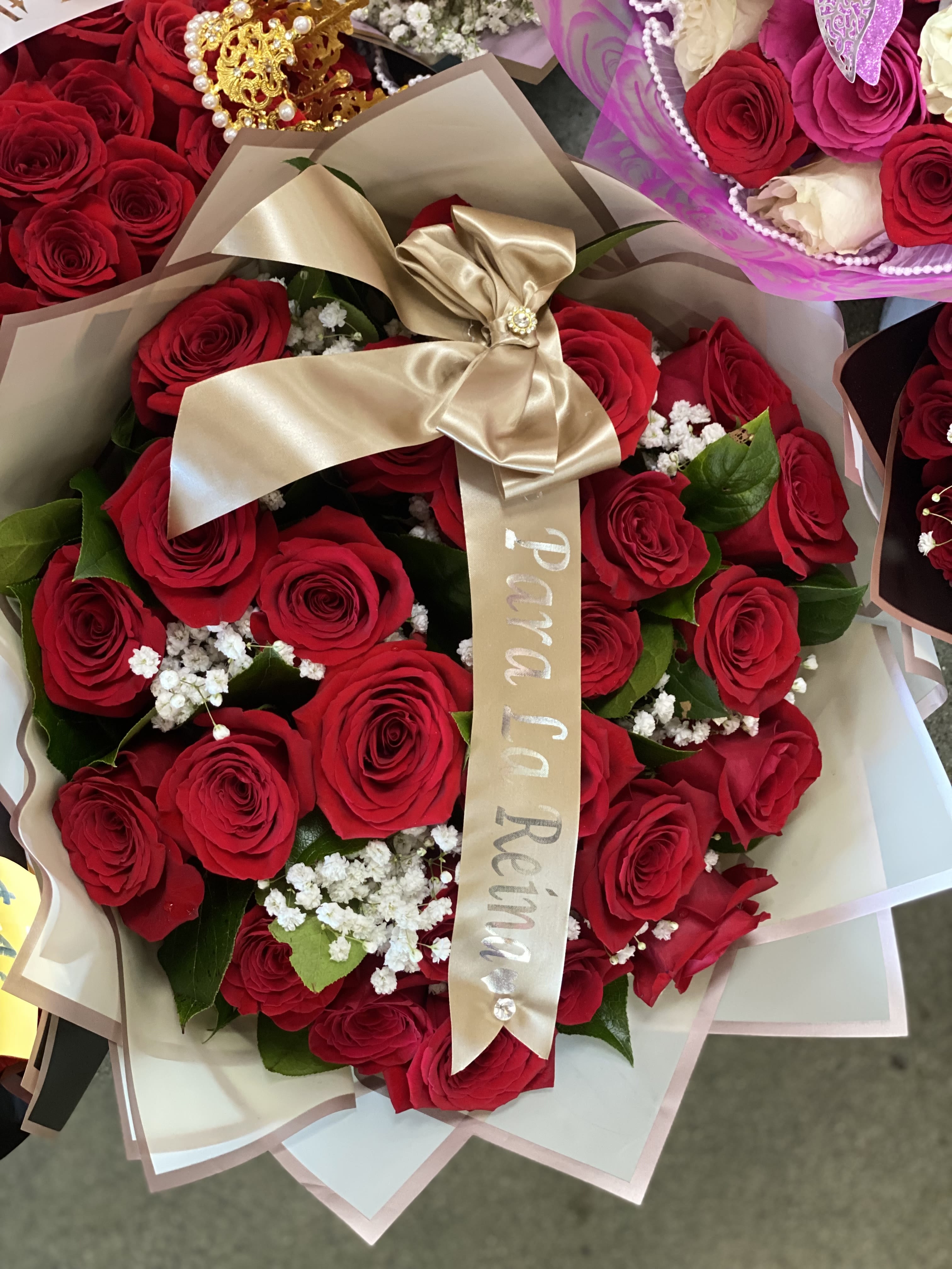 Bouquet of red roses wrapped with a gold ribbon