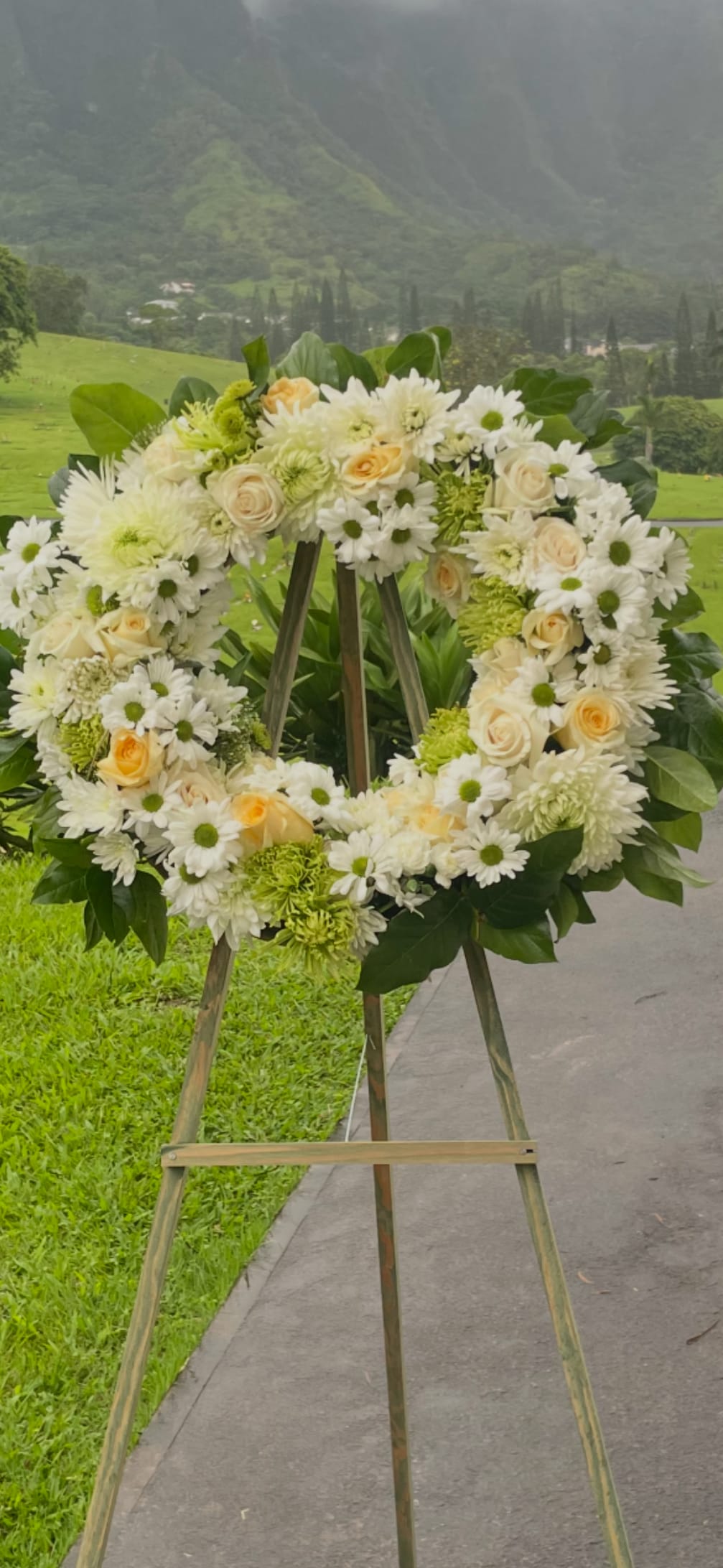 Lasting Serenity by BloomNation™  - A beautiful white and green tribute wreath that calms, this easel arrangement celebrates a full life and a peaceful passing. 