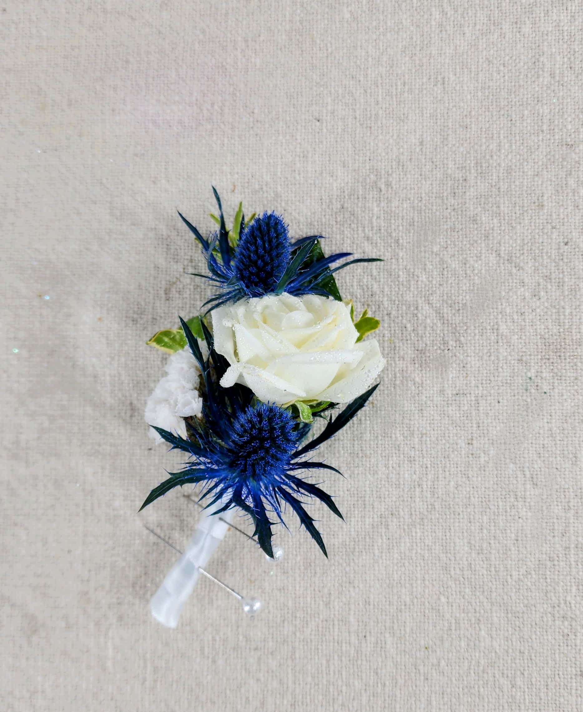 Boutonniere A White Night of the Blues  - This boutonnière is perfect for the man who wants some color added to their attire.  