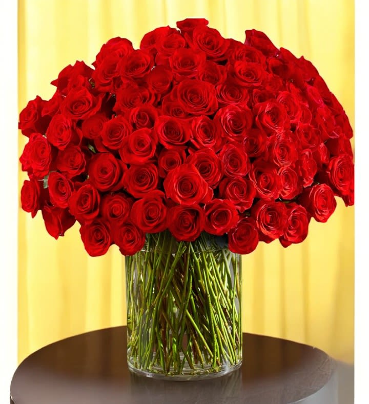 Large bouquet of red roses in a clear glass vase