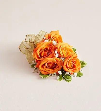 Orange Spray Rose Corsage - A bright and cheerful floral set featuring an orange spray rose wrist corsage on a flexible, adjustable wristlet, paired with a matching boutonniere. Perfect for proms, weddings, or special occasions, this coordinated combo adds a vibrant pop of color and ensures a polished, harmonious look. The corsage beautifully accents the wrist, while the boutonniere complements it for a stylish and memorable floral pairing