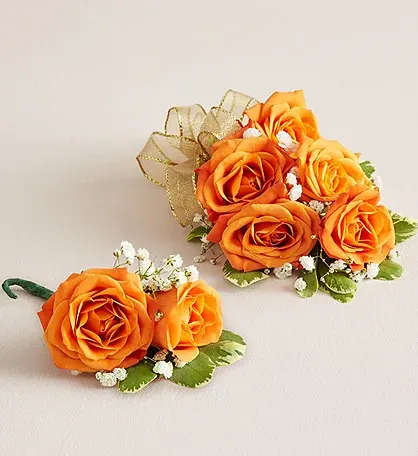 Orange Spray Rose Corsage Buttoners Combo. - A vibrant and coordinated floral set featuring an orange spray rose wrist corsage on a flexible, adjustable wristlet, paired with a matching boutonniere. Perfect for weddings, proms, or special occasions, this set ensures a polished and harmonious look for couples or attendees. The corsage adds a cheerful pop of color to the wrist, while the boutonniere complements it beautifully, creating a stylish and memorable floral pairing.
