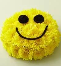 Smiley Face Bouquet - A fun and cheerful smiley face bouquet crafted with bright yellow cushion mums to create a happy, smiling design. This playful arrangement is designed to bring joy, laughter, and positivity, making it a perfect gift to brighten someone’s day.  Whether celebrating a birthday, sending get well wishes, or simply sharing a smile, this unique bouquet is sure to lift spirits and spread happiness wherever it’s displayed.