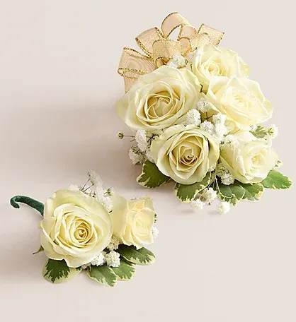 White Spray Rose Corsage and Buttoner Combo - A classic and coordinated floral set featuring a white spray rose wrist corsage on a flexible, adjustable wristlet, paired with a matching boutonniere. Perfect for weddings, proms, or special occasions, this elegant set creates a polished and harmonious look for couples or attendees. The corsage adds a timeless touch of beauty to the wrist, while the boutonniere complements it perfectly, making a stylish and memorable floral pairing.