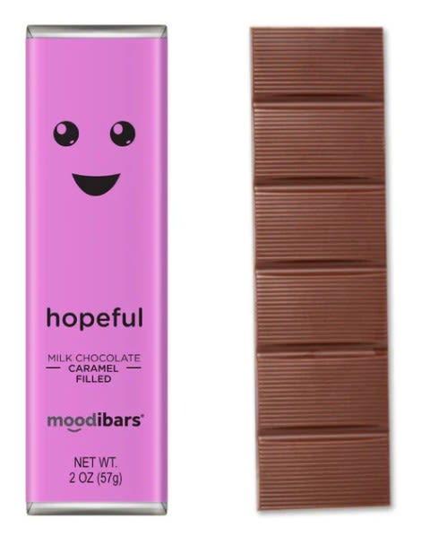 Pink chocolate bar wrapper beside a segmented milk chocolate bar