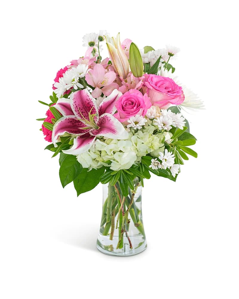 Pink lilies and roses in a clear glass vase