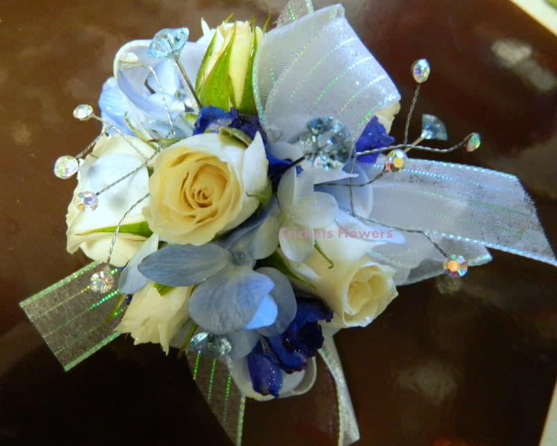 Small bouquet of cream and blue flowers with ribbon and crystal picks