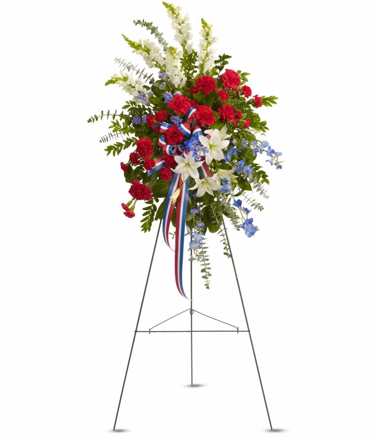 Standing floral spray with red, white, and blue flowers on an easel