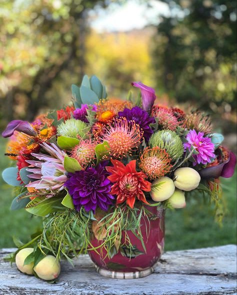 The jewel - a arrangement in Jewel colored tones Exotic array of Hawaiian Tropic blooms A mixed tropical bouquet with a  mainland feel this arrangement with secondary Flowers is depending on floral availability due to seasonal Florals provided by our farm all flowers are handpicked by freshness and available by season but always fresh and beautiful  