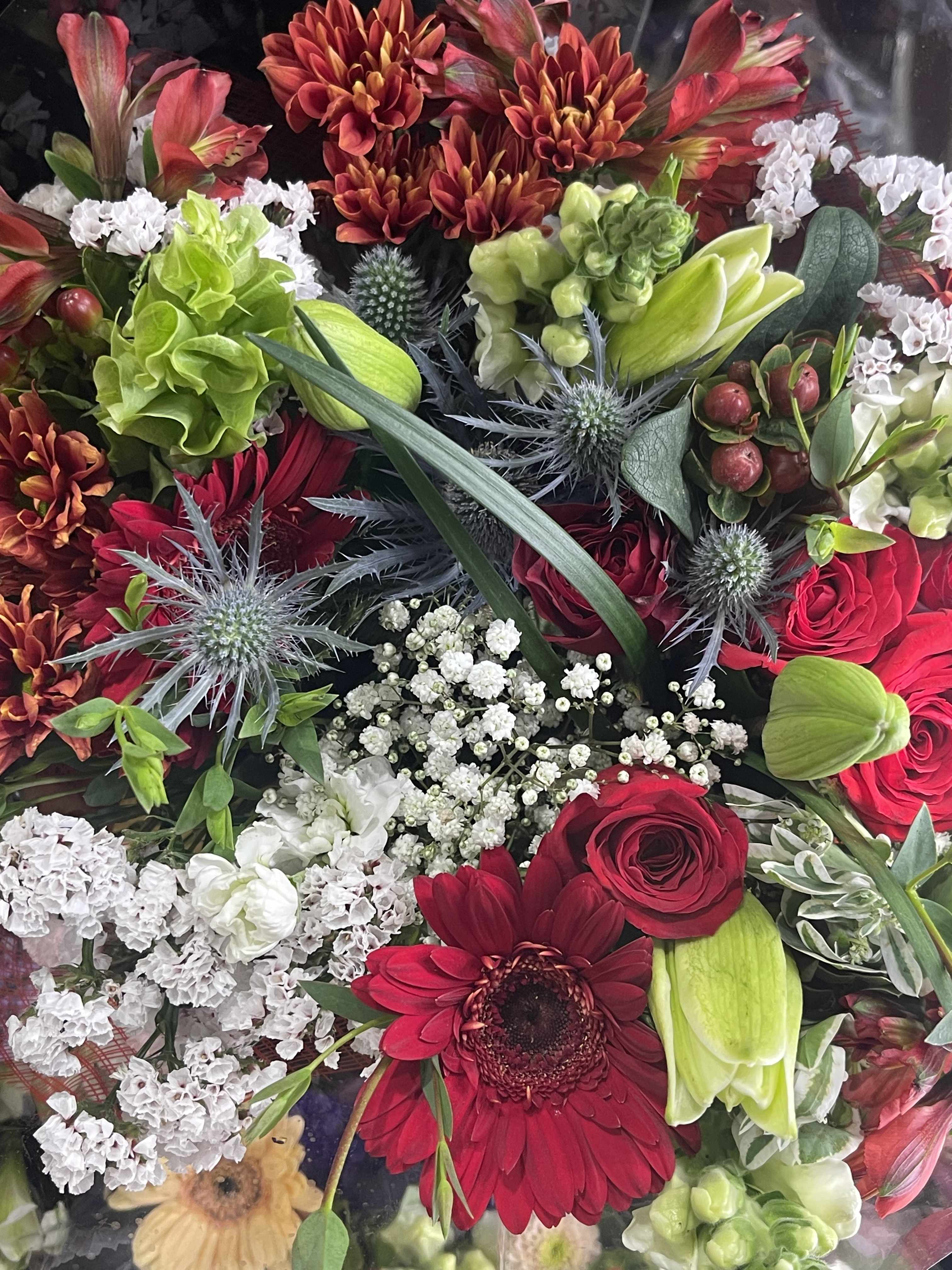 Red and white  - This red and white floral bouquet is designed with romance in mind is beautiful dry wrap bouquet will showcase your florals in a red and white color palette With hints of color, a kiss of Blue and green of mixed cottage blooms