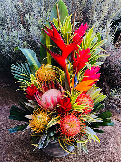Island Romance (NATIONAL SHIPPING) - May 6 will be the deadline for ordering for Mother’s Day. Your arrangements will arrive before Mother’s Day. Any orders after May 6 your flowers will arrive 2 to 3 days estimation, after Mother’s Day  Indulge in the essence of an island getaway with "Island Romance" from Tropical Florals Hawaii. This stunning bouquet features the best of locally grown exotic blooms from Hawaii, carefully selected for their unique beauty and charm. With its bold, energetic mix of tropical flowers, "Island Romance" is the perfect way to express your love and admiration for that special someone. From the fiery reds of the anthurium to the delicate whites of the ginger flower, each bloom exudes a unique tropical beauty that is sure to captivate. And the best part? "Island Romance" can be shipped anywhere in the United States through FedEx. So whether you're near or far, you can still savor the romance and beauty of this stunning arrangement. So why wait? Let "Island Romance" transport you to a world of love and beauty, all from the comfort of your own home.  Island Love $310  *Flowers may be substituted for equal or lesser value depending on availability  fedEx_tiny SHIPPING INCLUDED  Read about our delivery schedule