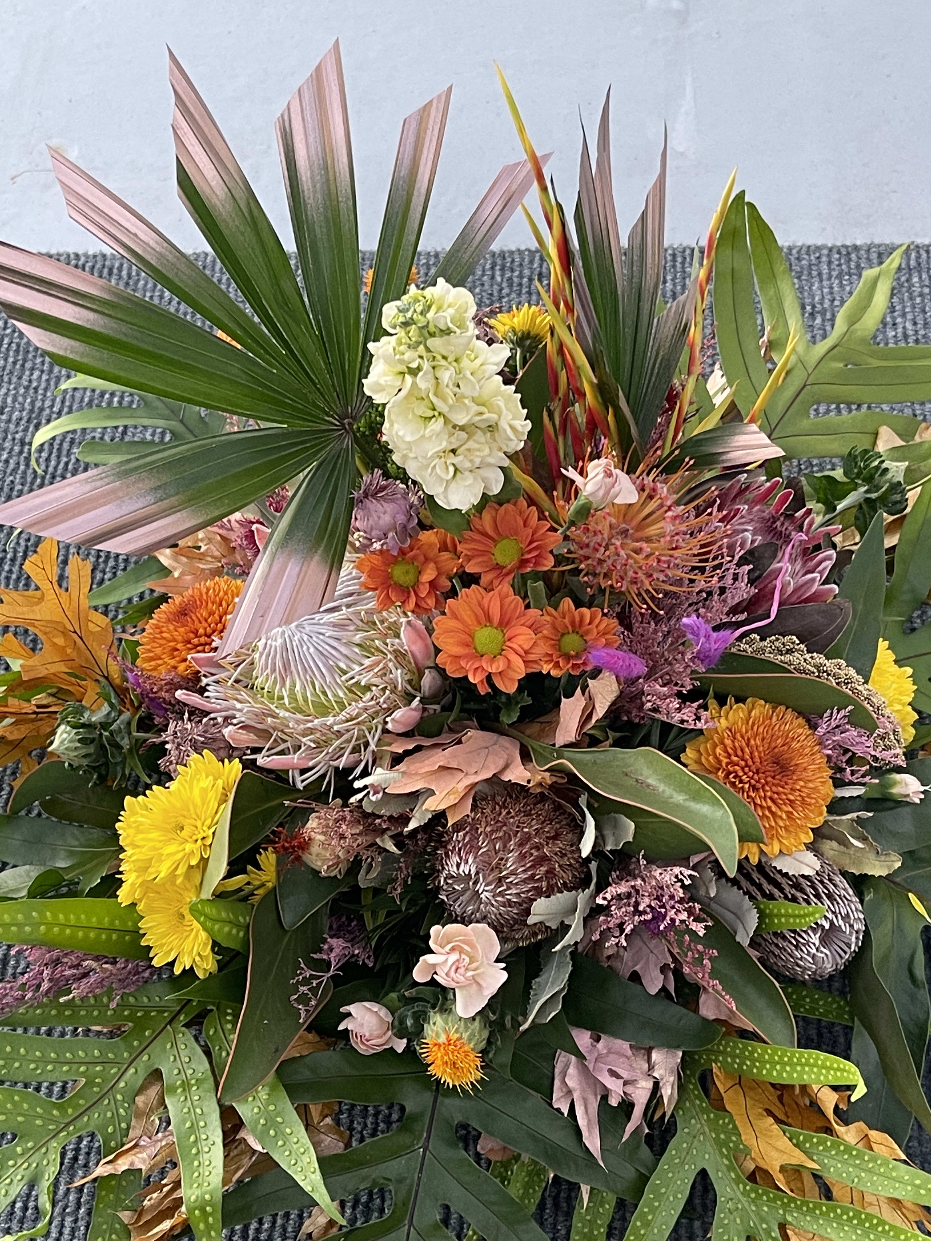 Seasonal fall centerpiece  florist choice  - A premium selection of autumn inspired fall colored blooms and greenery A mixed selection I have Protea and beautiful fresh cut flowers with a mix of autumn decor