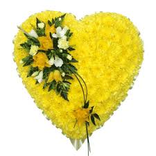  heart of Heavenly whispers    - This solid yellow heart arrangement displayed on an easel perfect for any funeral services or grand openings Or a heartfelt gesture. All of the yellow lovers out there this arrangement will share please 