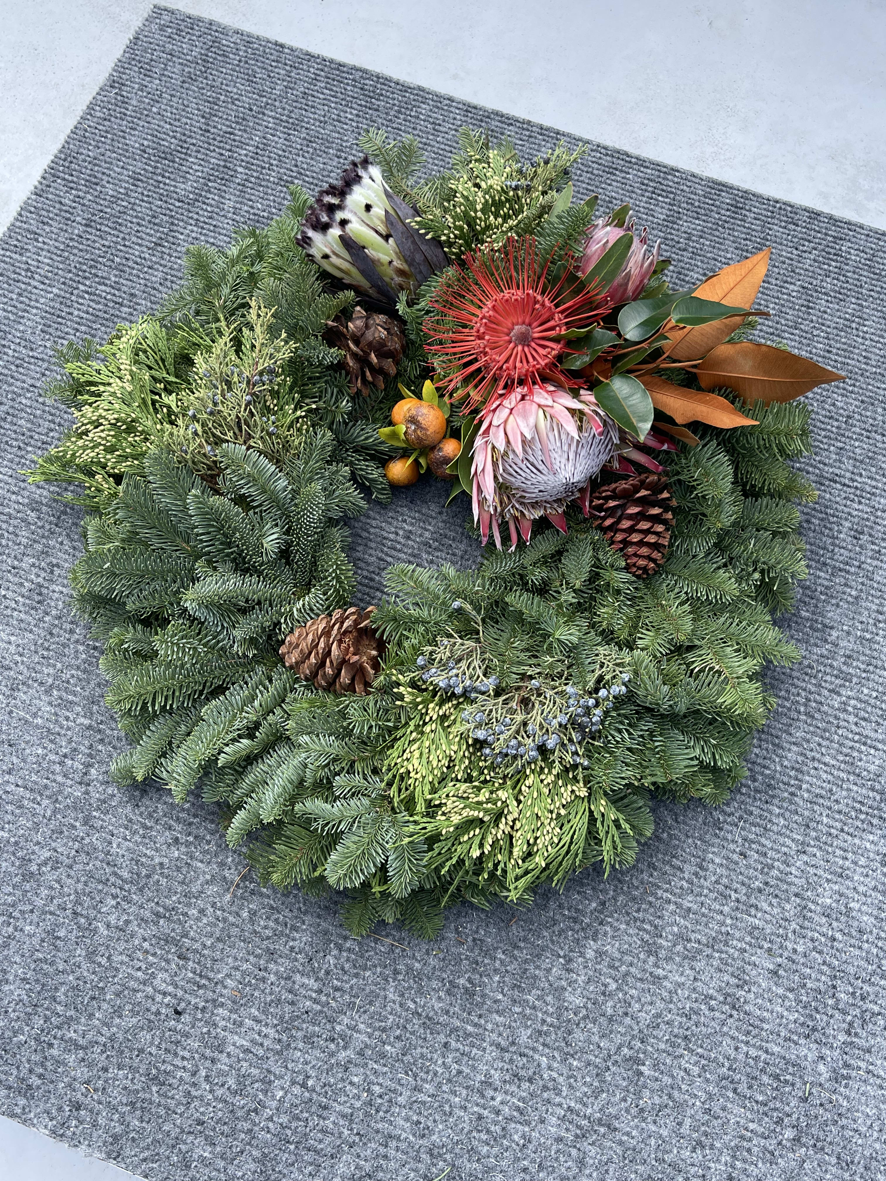 Hawaiian holiday wreath With gold and white decor  - Is holiday wreath include gold and white decor with fresh pine Fragrant eucalyptus This Hawaiian holiday wreath fresh exotic greens locally grown complemented with Oregon Evergreens 
