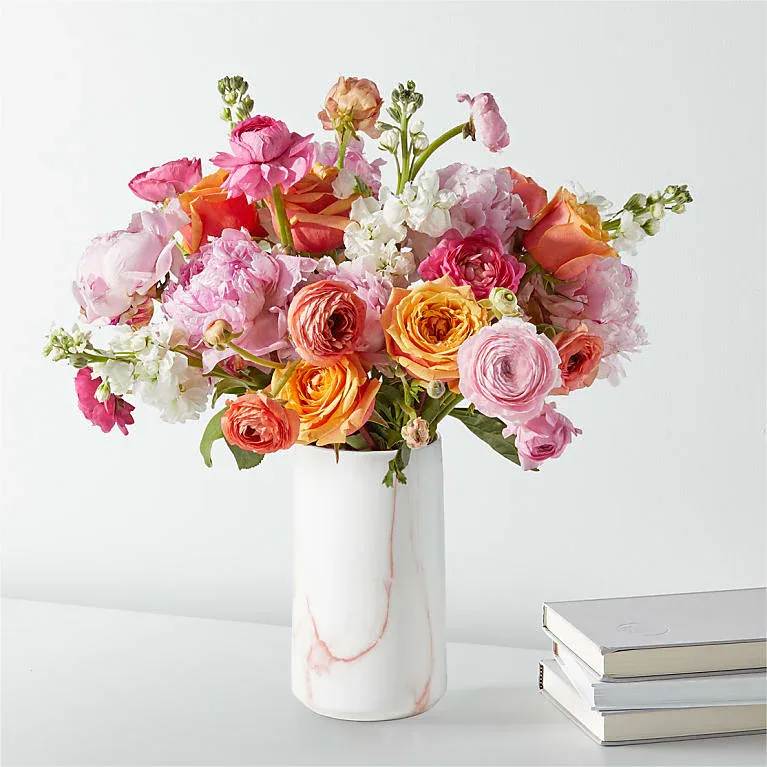 Peony &amp; Ranunculus Garden Bouquet - Bring the beauty of the garden indoors with this elegant bouquet featuring roses, peonies, and ranunculus. It includes approximately 25 stems of fresh flowers and foliage and comes with a pink marble vase. Floral food and care instructions are also included, carefully packed in a gift box. Upon arrival, trim the stems at an angle and place them in room temperature water with the provided flower food. To keep the blooms fresh longer, change the water daily. Vase may be substituted with a similar white design based on availability. 