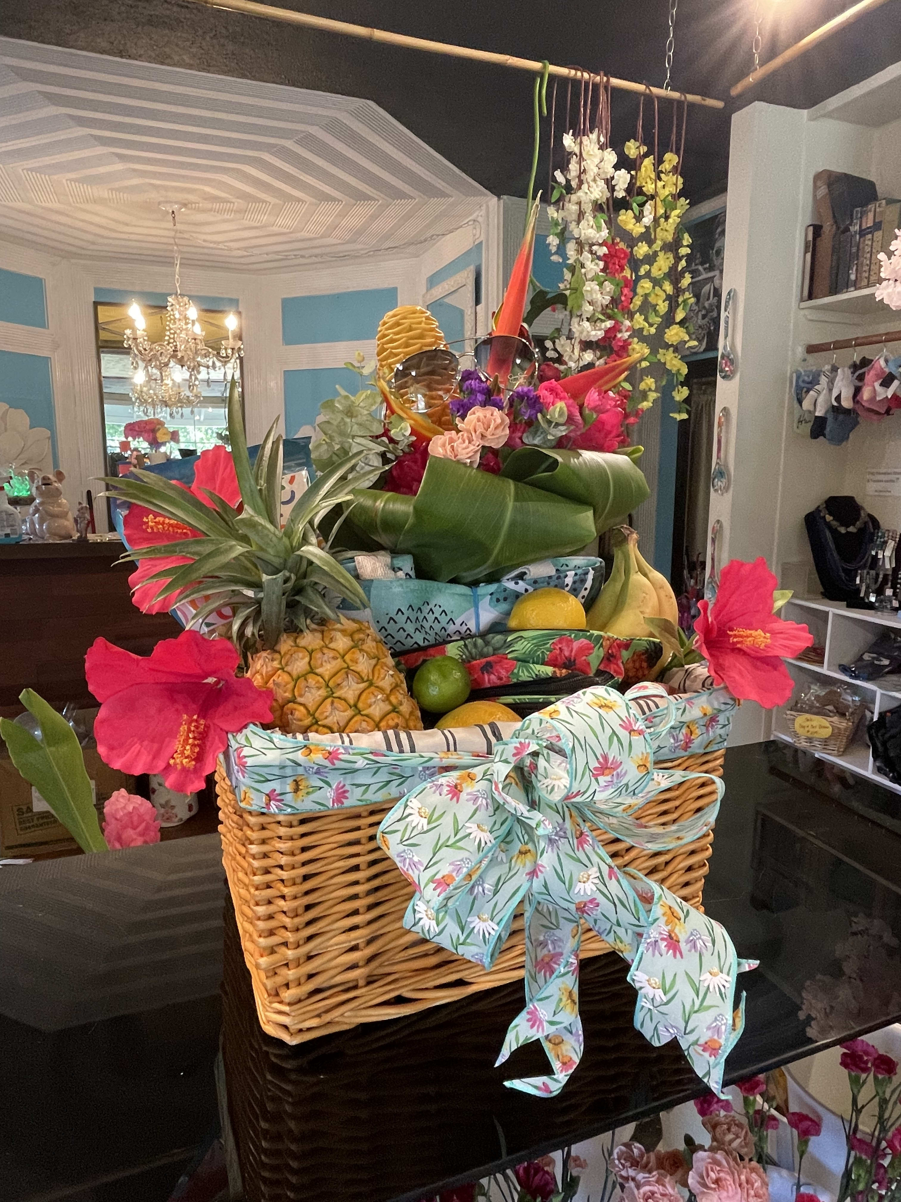 Luxurious  Welcome to Hawaii basket  -  Local fresh fruits popcorn chocolates and so much more in this luxurious A fun selection  of assorted accessories  hand selected treats  exotic  fruits  floral arrangement with this fun basket to welcome your lovely guests to Paradise
