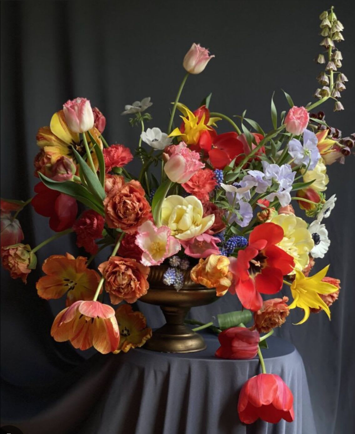 Colorful mixed flower arrangement in a pedestal vase