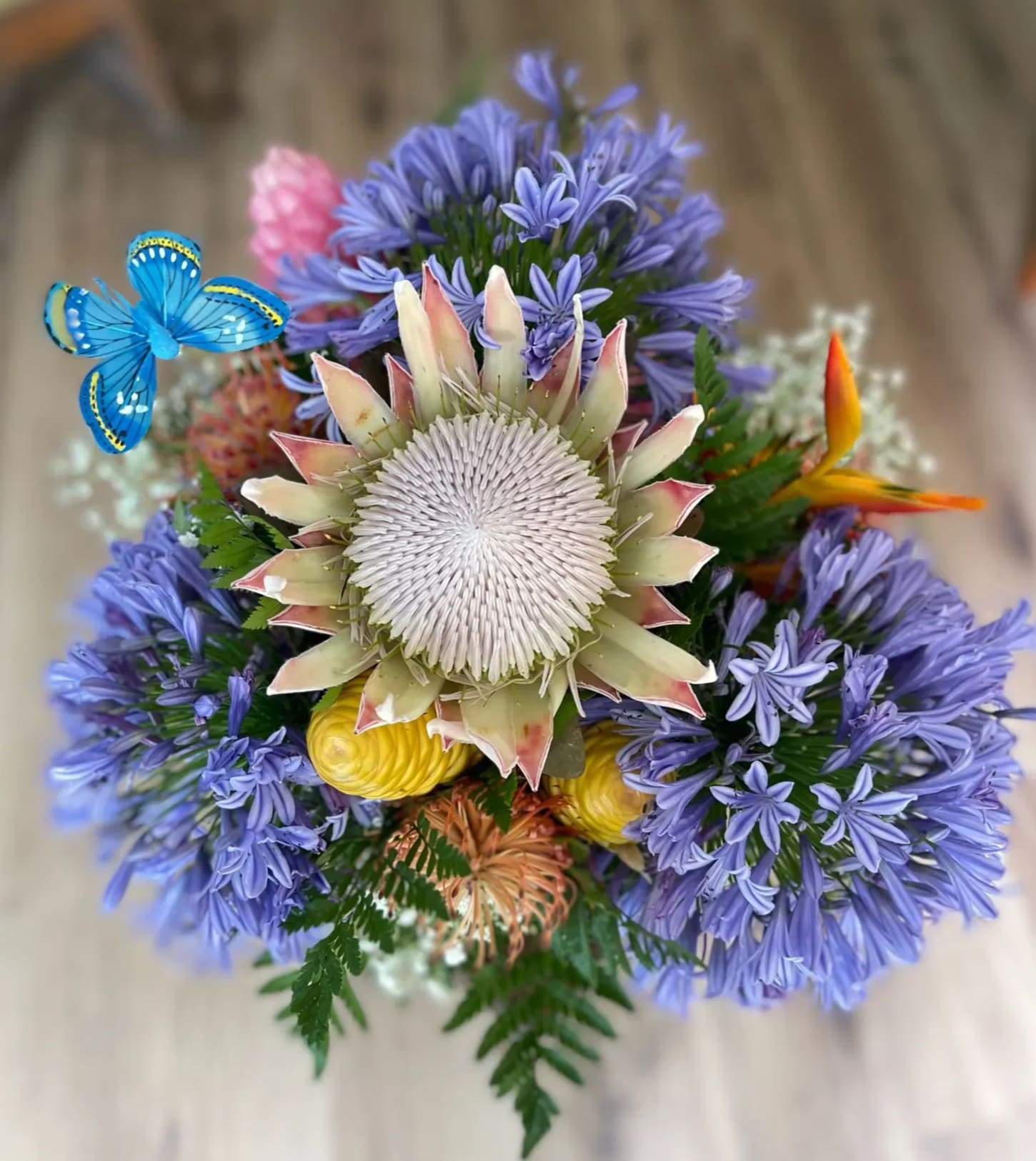 Paradise in a Vase  (OAHU ONLY) - "Paradise in a Vase" - an enchanting ode to the beauty of Hawaii, captured in a single vessel. This floral masterpiece transports you to a world of tropical wonder as it proudly stands tall in a classic glass vase, showcasing the essence of the islands.  From the pristine shores of Oahu to the vibrant landscapes of Maui, we have handpicked the freshest blooms to compose this stunning arrangement. Each petal tells a story, whispering secrets of sun-kissed beaches, swaying palms, and fragrant breezes. "Paradise in a Vase" is a symphony of colors, textures, and scents, inviting you to lose yourself in the embrace of Hawaii's natural splendor.  As you gaze upon this creation, let your imagination soar across azure skies, golden sunsets, and lush valleys. Let the beauty of Hawaii infuse your space, bringing a touch of paradise into your home. "Paradise in a Vase" is a poetic testament to the captivating allure of the islands, an everlasting reminder of the magic that blooms in the heart of Hawaii.