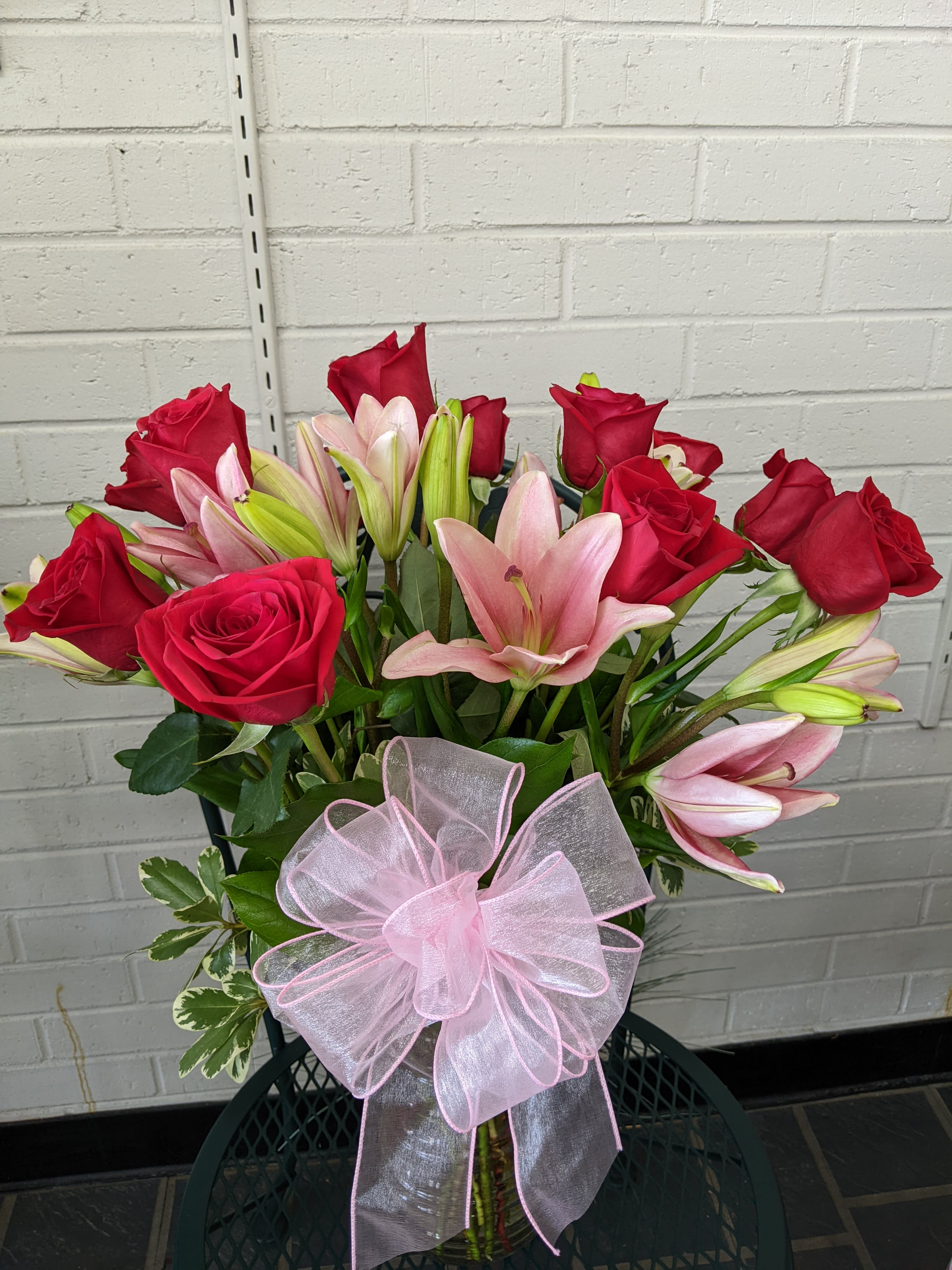 Summer Lovin' - A classic dozen roses paired with half dozen beautiful lilies! And what is summer without lilies? What is love without roses? Together these are the perfect combination of summer love! 