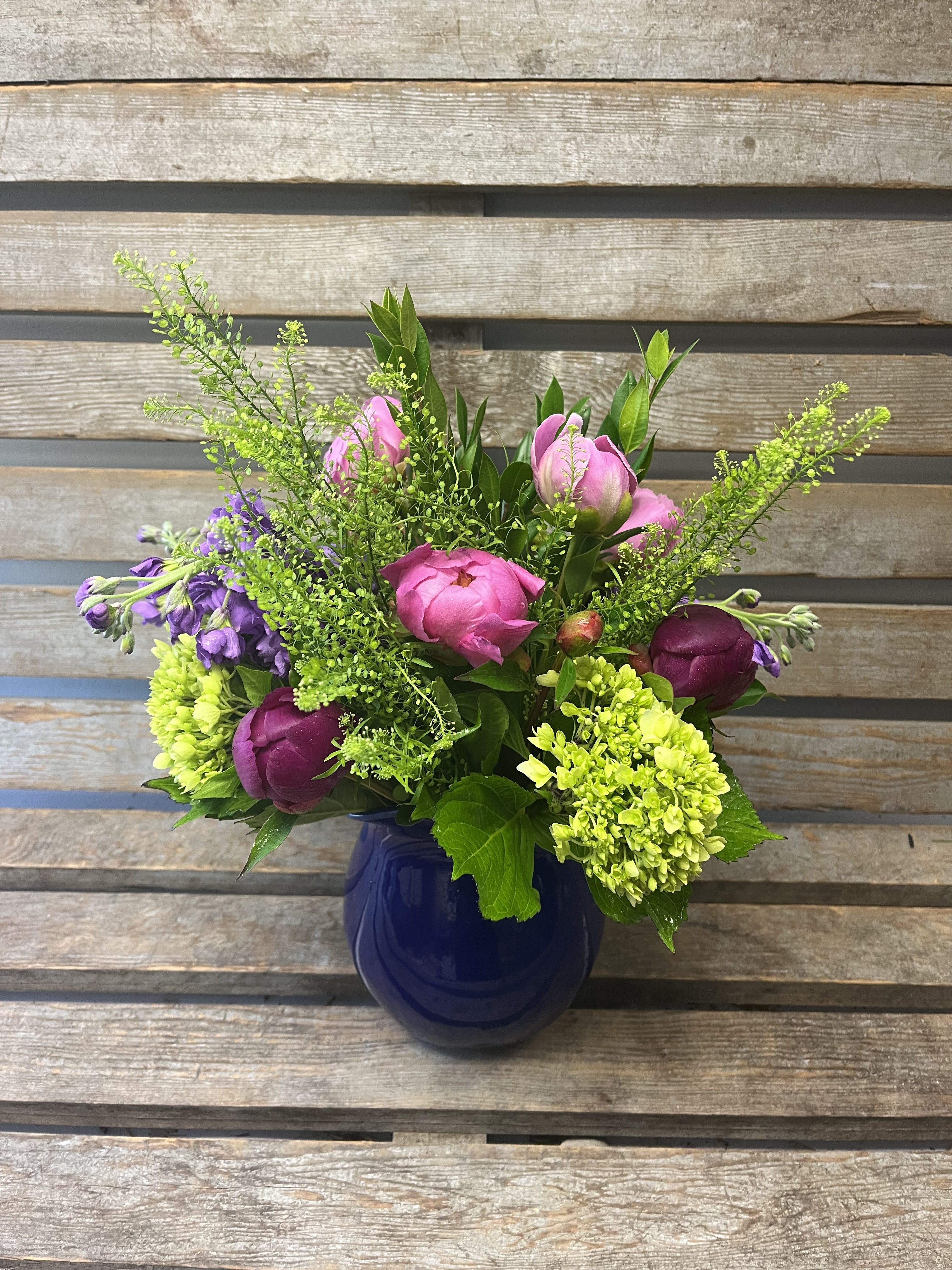 Peony pitcher  - Cobalt blue pitcher filled with seasonal Peonies, summer stock, and hydrangea. Shades of blue, green, lavender, fuchsia.