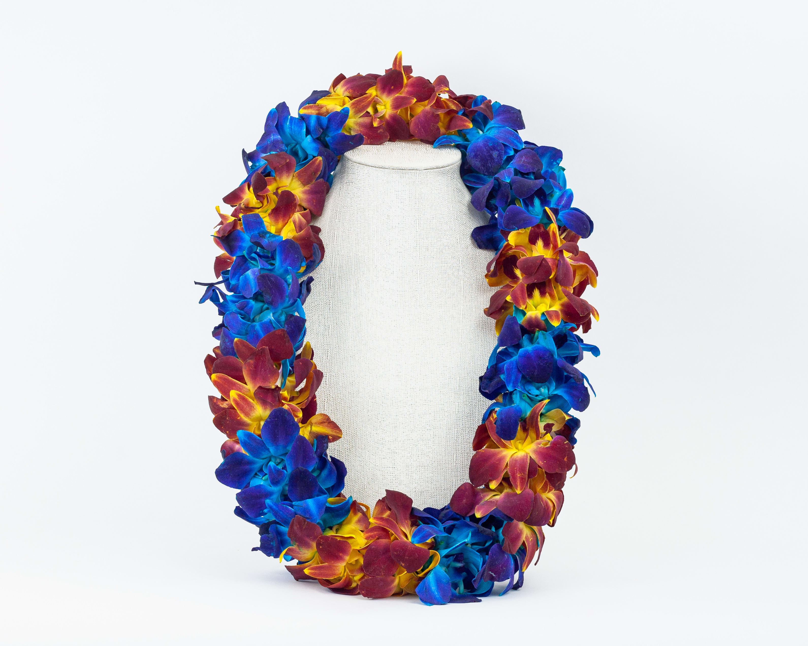 Colorful flower lei draped over a white mannequin bust