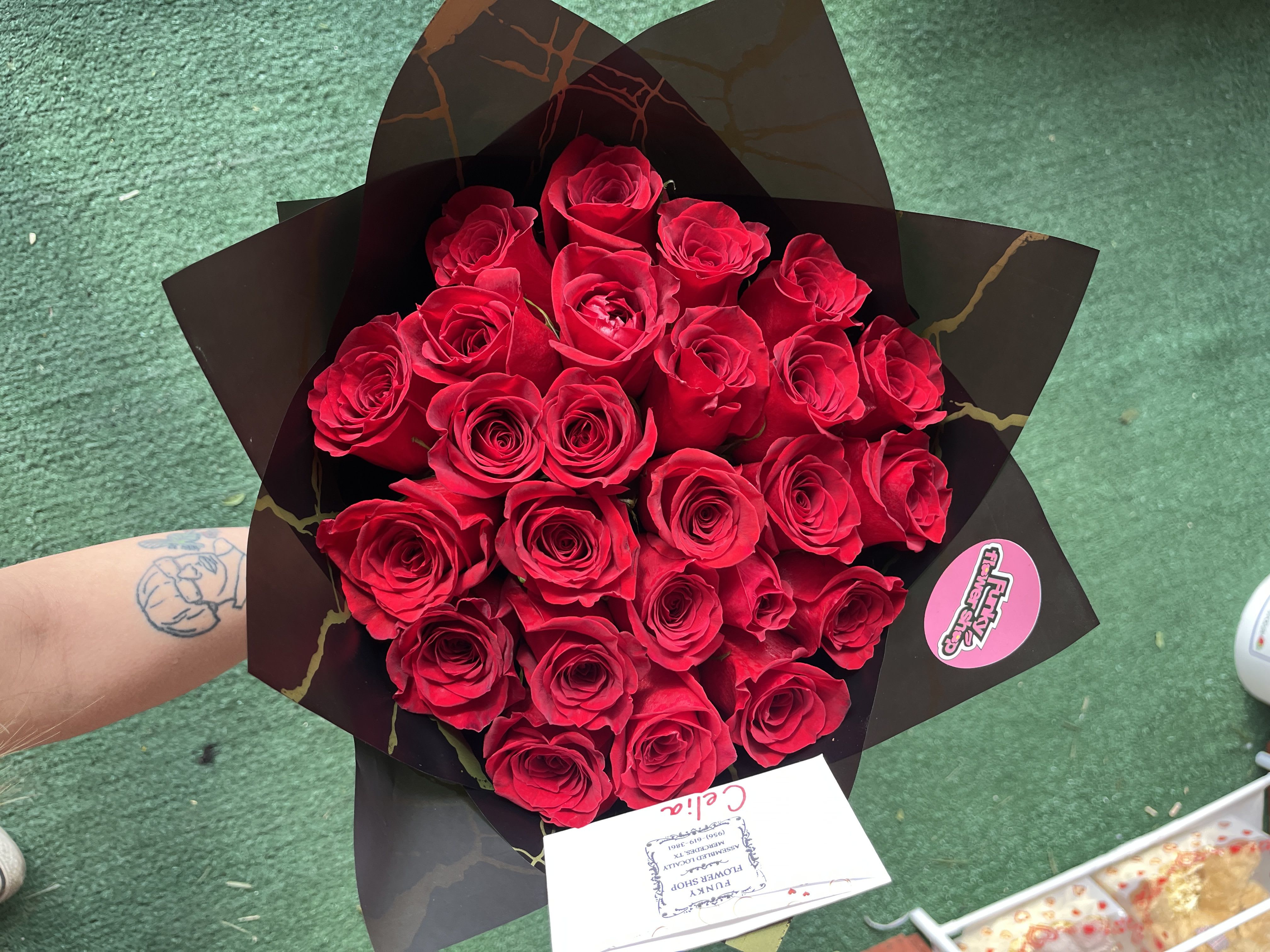 Bouquet of red roses wrapped in black paper