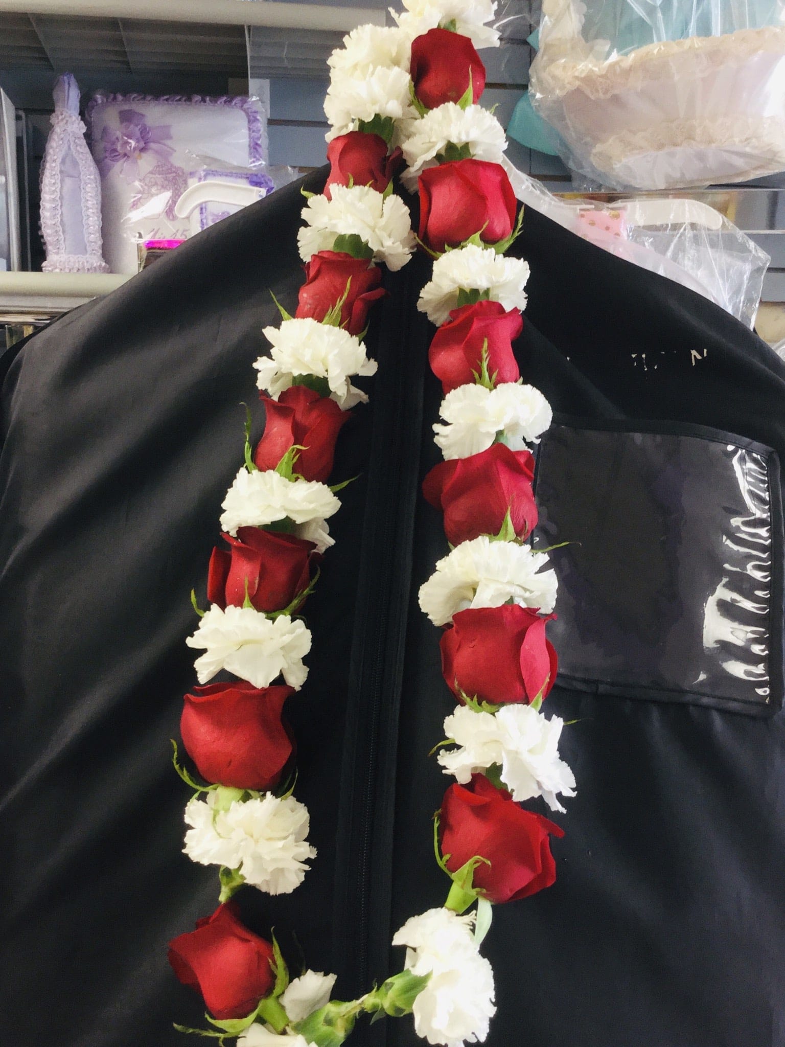 Red roses and white carnations arranged in two hanging garlands