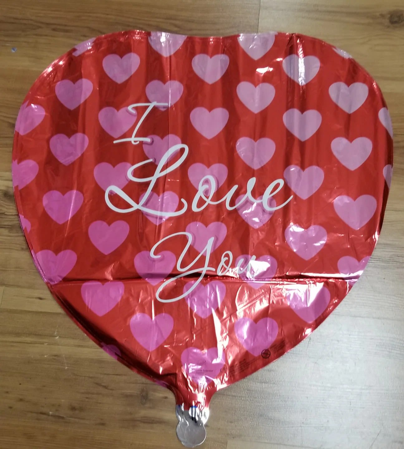 Heart-shaped red balloon with pink hearts and the words "I Love You"