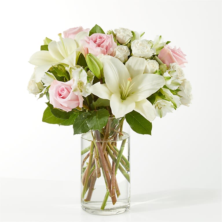 FTD Kindhearted  - Perfect for sharing comfort, sympathy, or heartfelt support, the FTD Kindhearted bouquet offers a gentle way to show you care. It features a serene mix of white lilies, roses, carnations, and soft greenery for a calm, comforting feel.