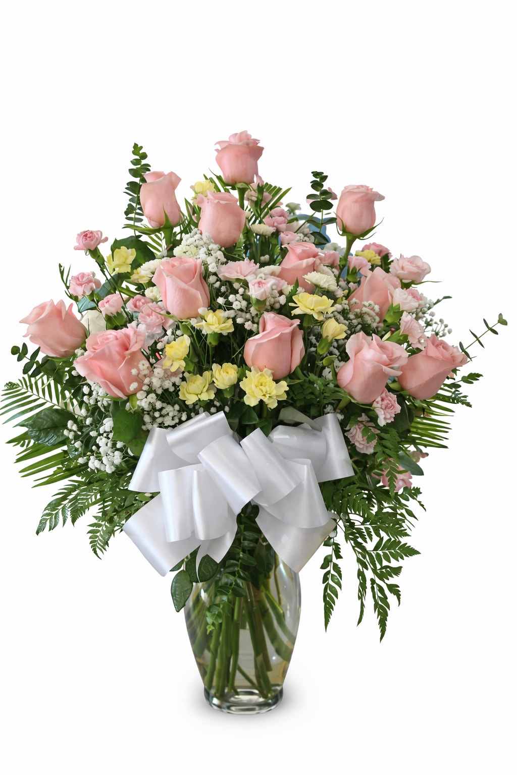 Pink roses and mixed flowers in a glass vase with a white bow
