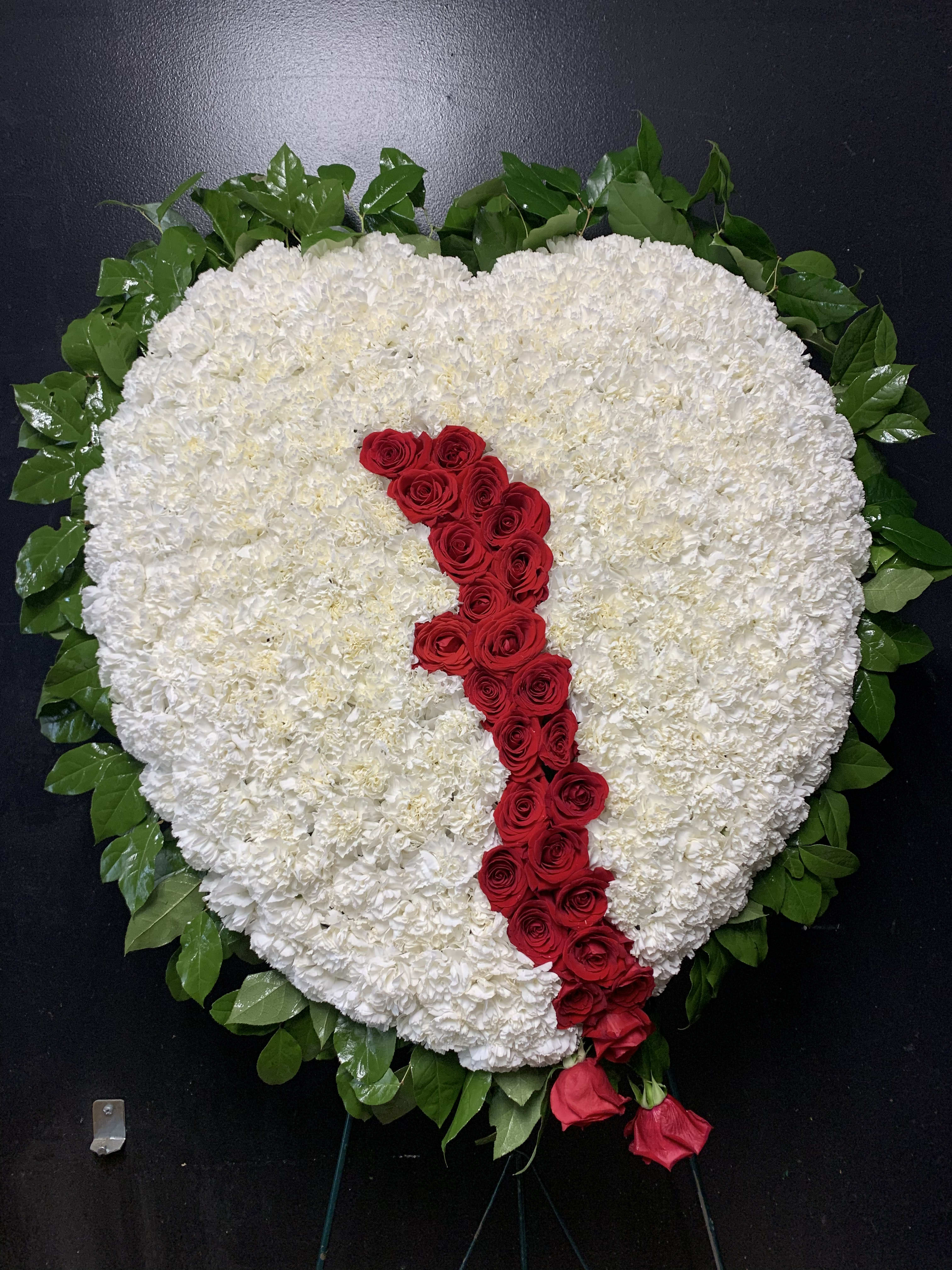 Heart-shaped white floral wreath with a red rose stripe and green border