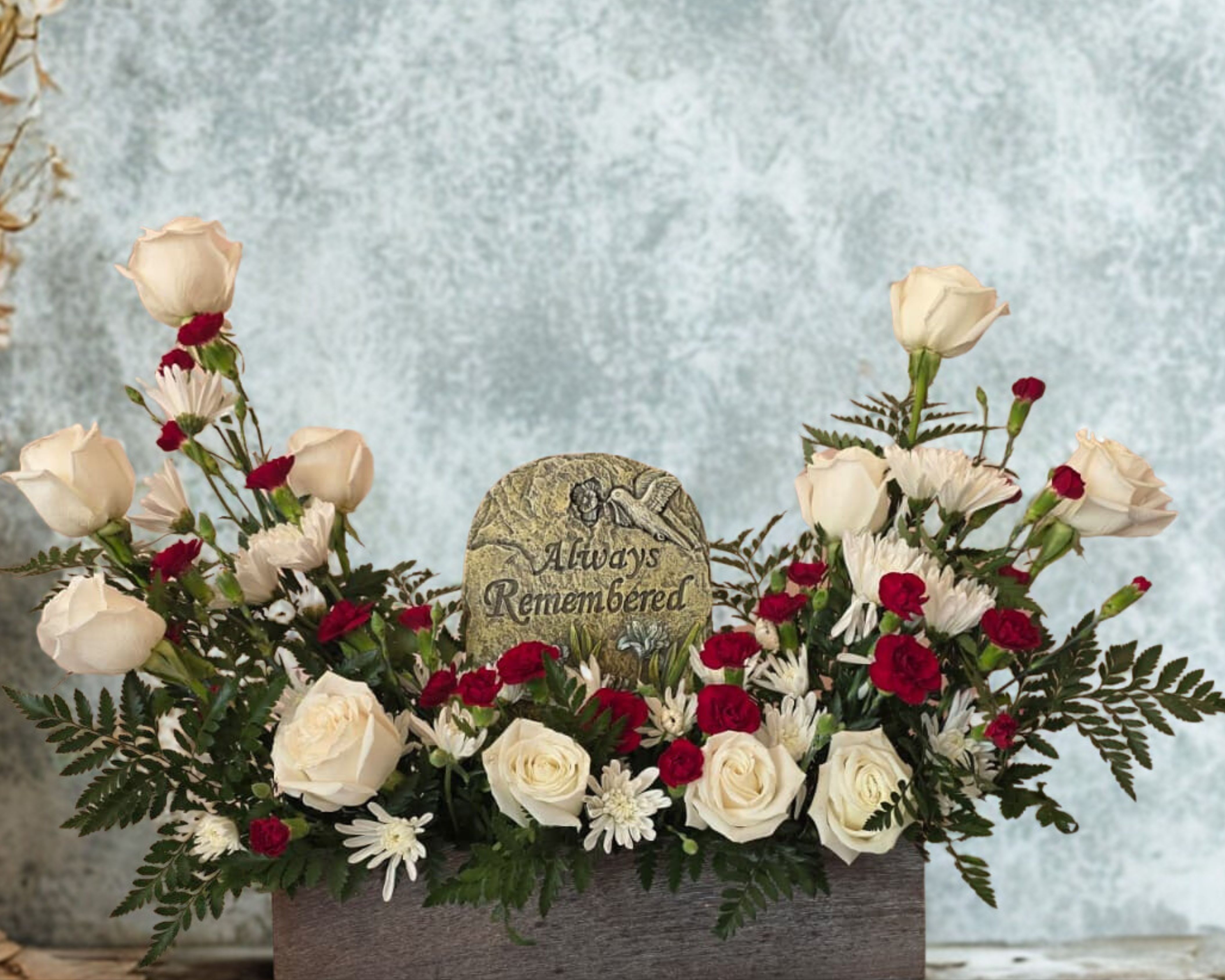 White and red rose arrangement with a memorial stone centerpiece