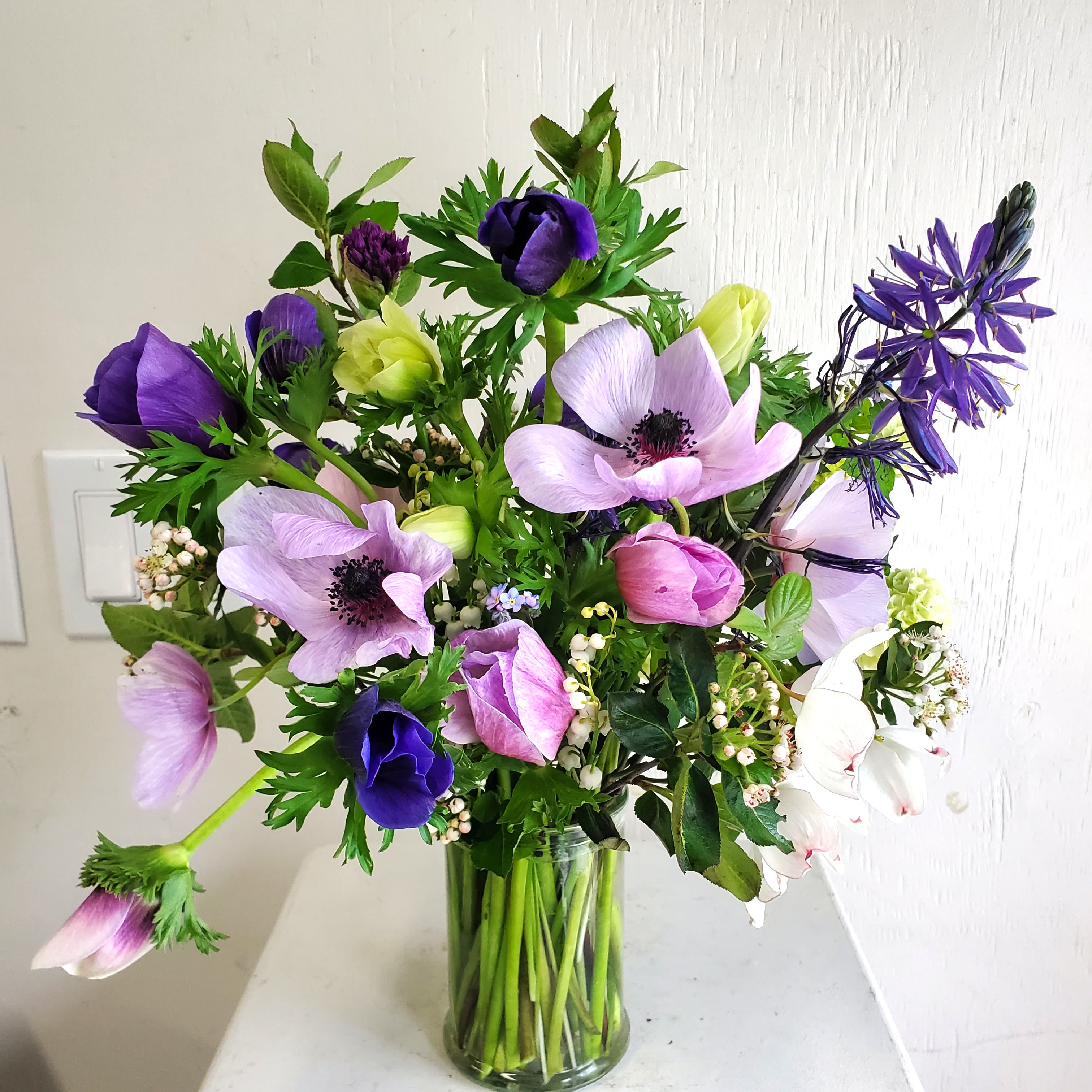 May- (Growers Choice) Anemone Bouquet  - We are a small studio florist in a small town. Every bouquet we create is a one-of-a-kind creation, tailored to the season, availability of flowers, color choice, artistic interpretation, and the current materials available. The photos do not represent the exact flowers that will be delivered. They are intended to provide you with an idea of  the variance that can be expected.  The season, availability of flowers,interpretation, and the current materials available.