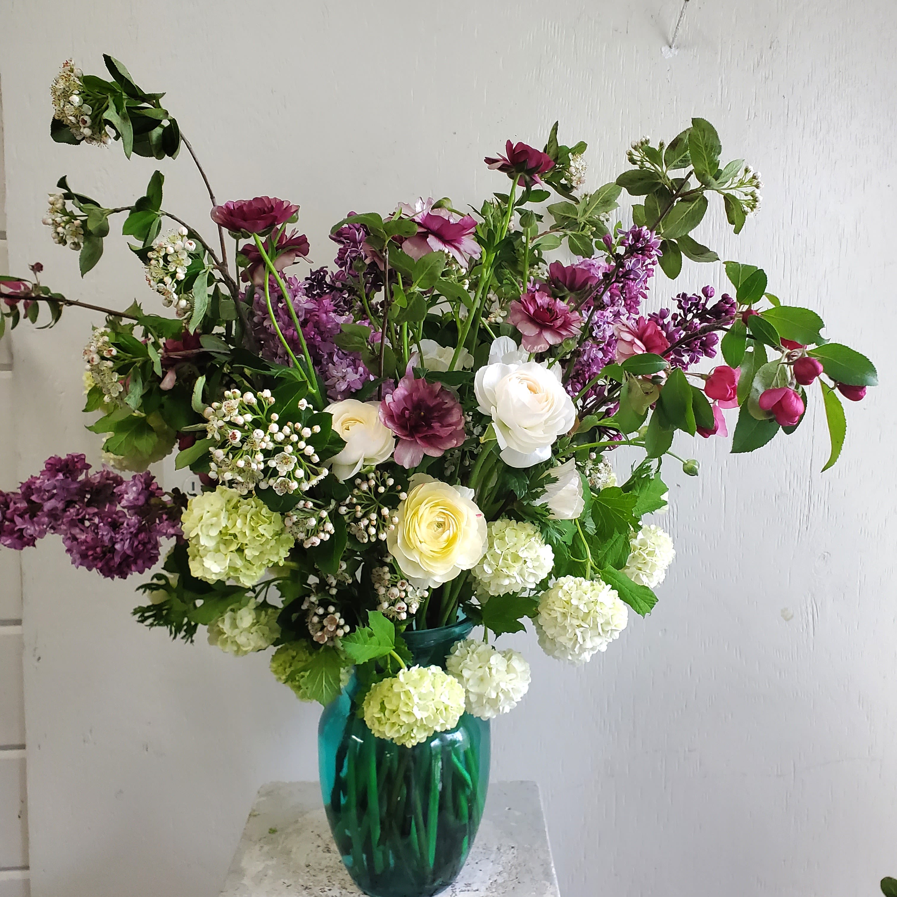Growers Choice Arrangement  - We are a small studio florist in a small town. Every bouquet we create is a one-of-a-kind creation, tailored to the season, availability of flowers, color choice, artistic interpretation, and the current materials available. The photos do not represent the exact flowers that will be delivered. They are intended to provide you with an idea of  the variance that can be expected.  The season, availability of flowers,interpretation, and the current materials available.  