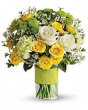 Your Sweet Smile - You could call or email that special someone, but why not put your feelings into flowers? She'll love this elegant array of white and yellow roses and other favorites in a stylish cylinder vase. She'll want to thank you in person. This charming bouquet includes white roses, yellow spray roses, green carnations, green button spray chrysanthemums and white waxflower accented with assorted greenery. Delivered in a glass cylinder vase. 