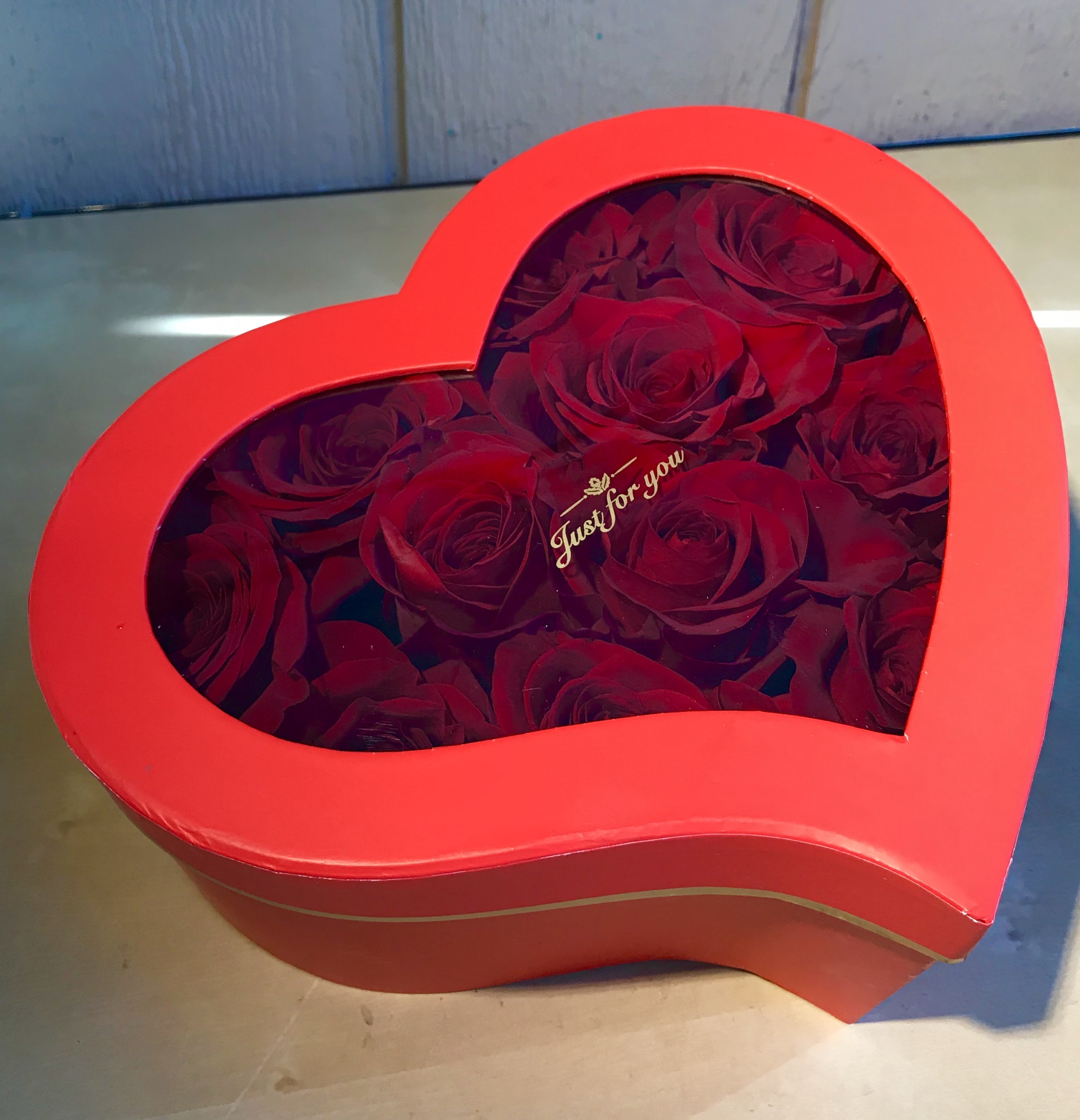 Heart-shaped red box filled with red roses