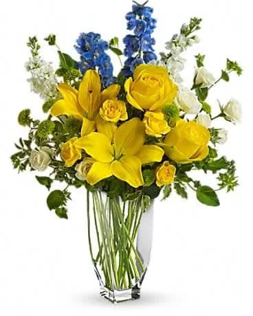 Meet Me in Provence - With a beauty reminiscent of the south of France, this proud and pretty arrangement holds nothing back. The colors, the flowers and the feeling of Provence are all present and accounted for in this wonderful bouquet. Yellow roses, spray roses and asiatic lilies, white spray roses and stock and the ever-delightful light blue delphinium are delivered in a Jewel Vase. C'est magnifique! 