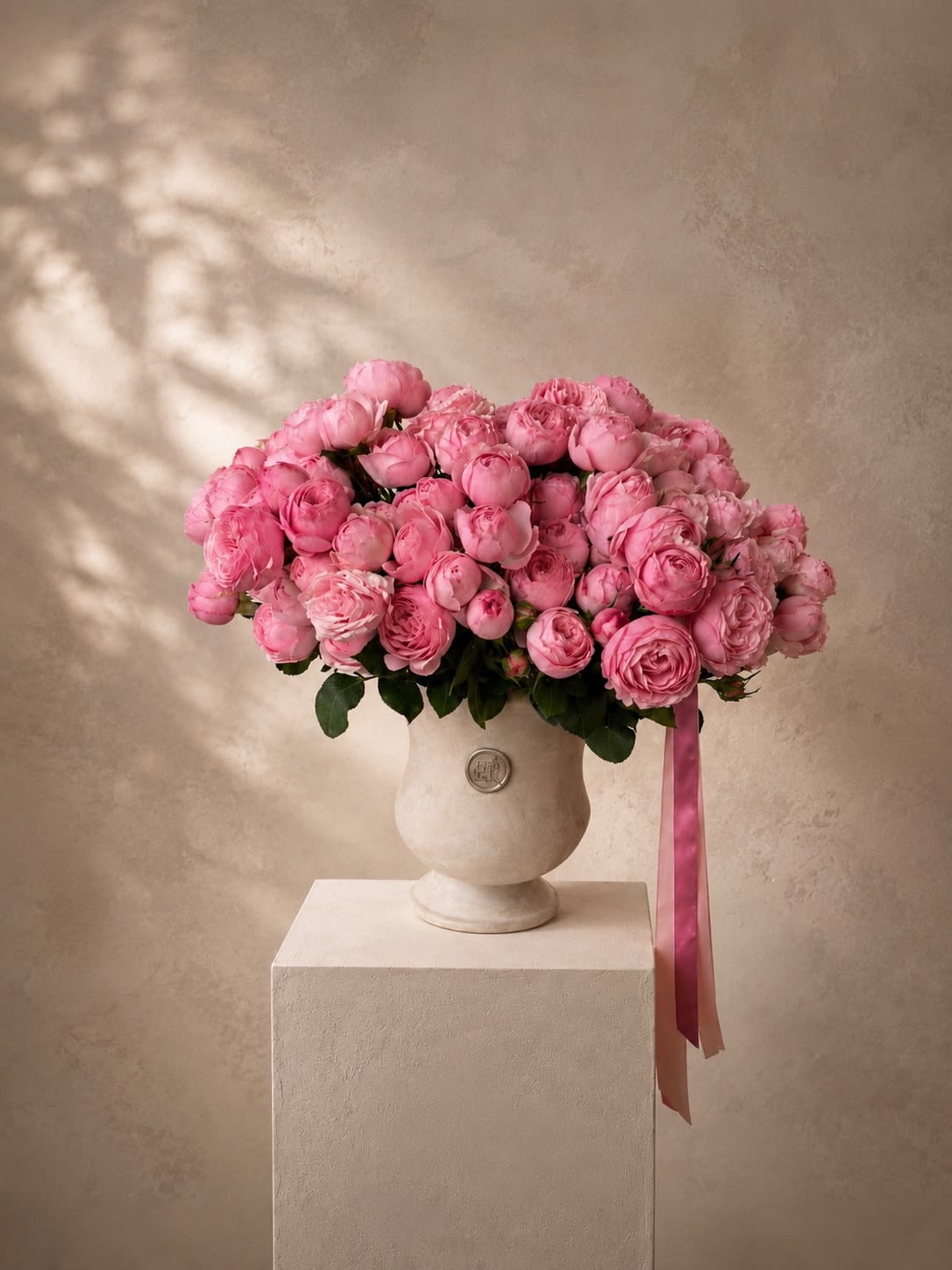 Juliet - Juliet is a romantic arrangement designed with luxurious pink garden spray roses, artfully arranged in an elegant urn for a timeless and feminine look. Soft, full blooms and delicate textures make this piece perfect for anniversaries, birthdays, or any moment worth celebrating beautifully.  This arrangement is not available for same-day orders, as it features specific premium garden roses that require advance sourcing. Please allow at least 24-hour notice. 