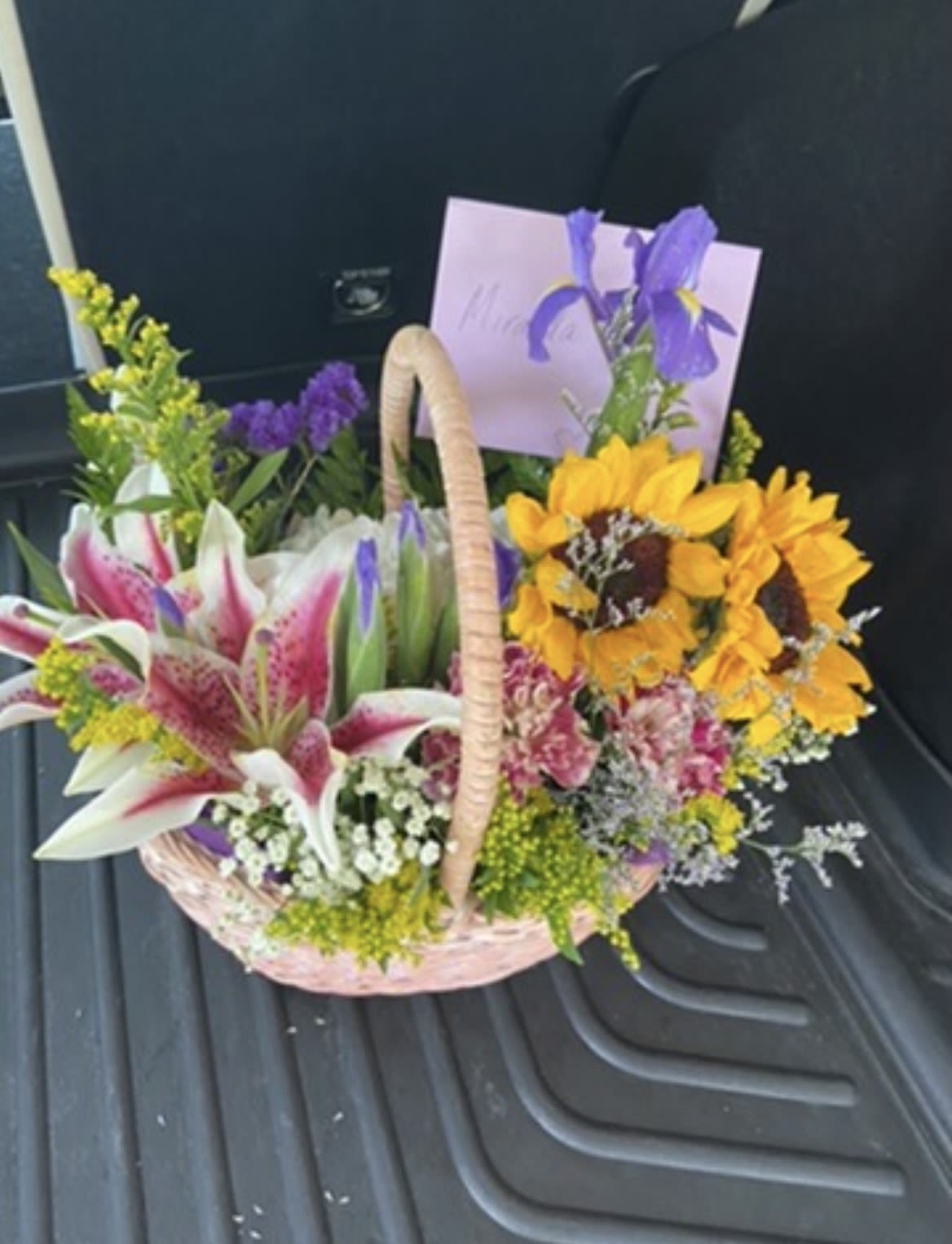 Golden Hour Garden Basket - A Custom Design by Wonderland Flowers - An uplifting garden-style basket filled with radiant sunflowers, fragrant stargazer lilies, vibrant iris, and soft seasonal blooms. Designed to feel like sunshine delivered! 