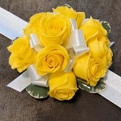 Yellow Corsage - Tight cluster of yellow roses with ribbon color accent on a snap bracelet. Boxed and ready to go!  Default Ribbon Color is white. Select from the "Make It Extra Special' to choose from our alternative ribbon colors. 